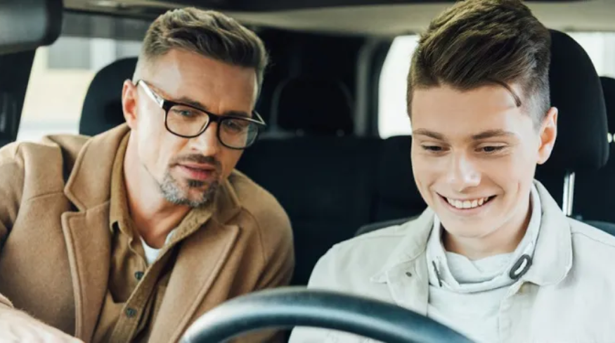 Dad teaching his teen how to drive.