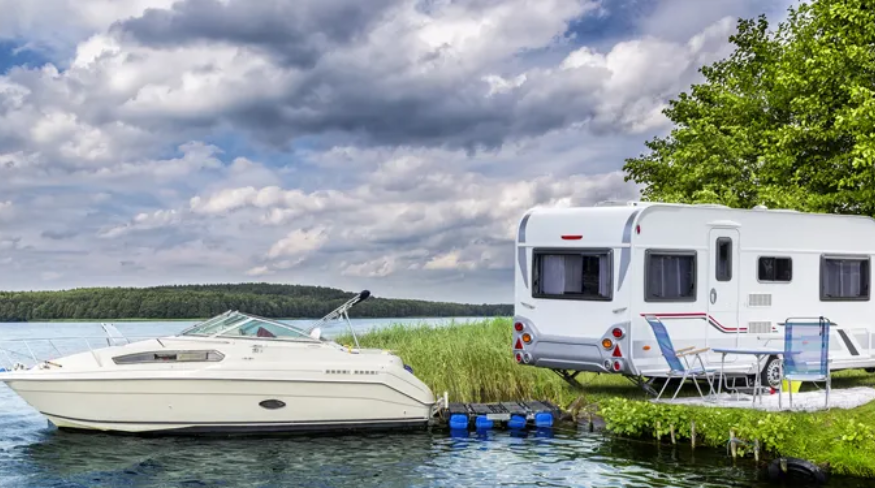 Camp site with a boat and RV.