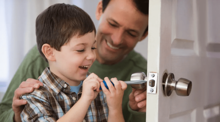 Father and son fixing the door.