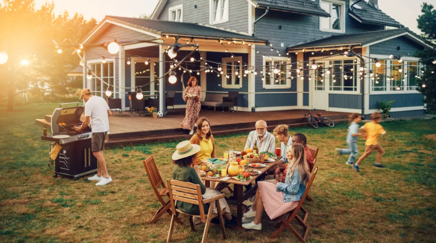 Family and friends enjoying a summer dinner outside.