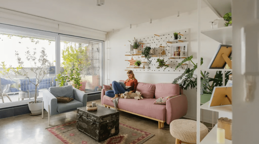 Girl sitting on couch reading.