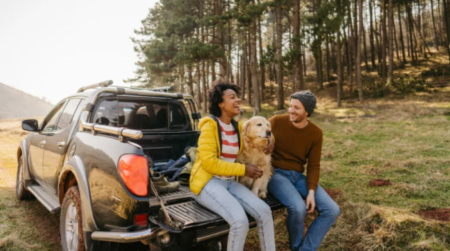 Couple on a road trip with their dog.
