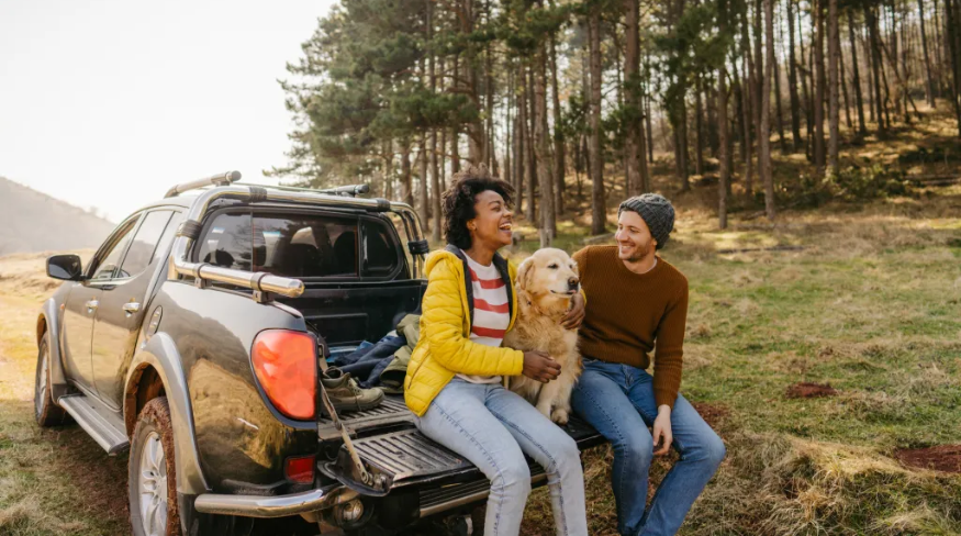 Couple on a road trip with their dog.