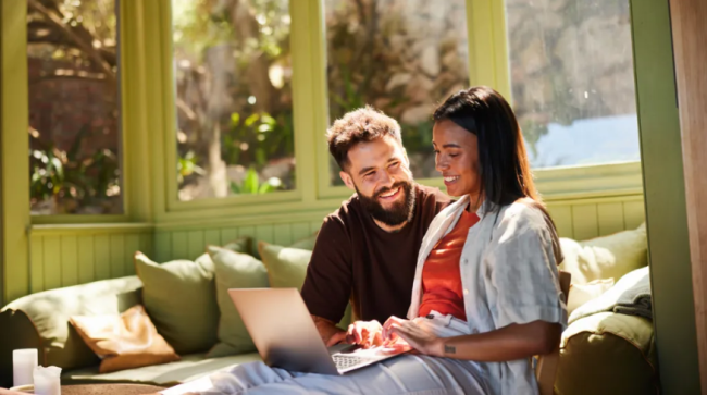 Young couple working on a laptop together.