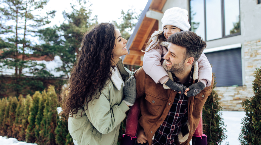 Happy family playing in the snow.