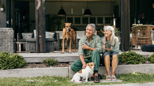 Happy couple sitting on front porch.