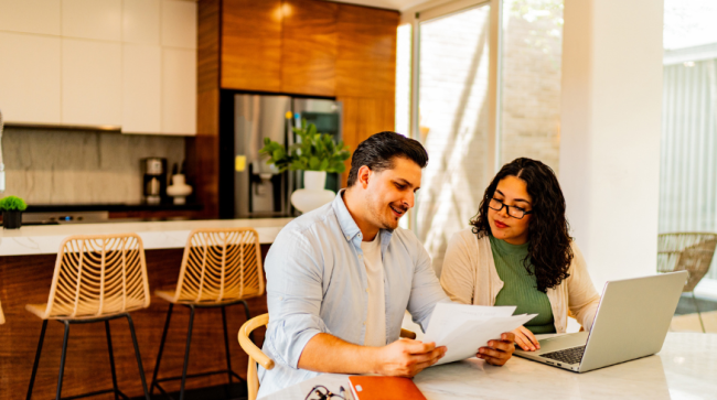 Couple reviewing home checklist.